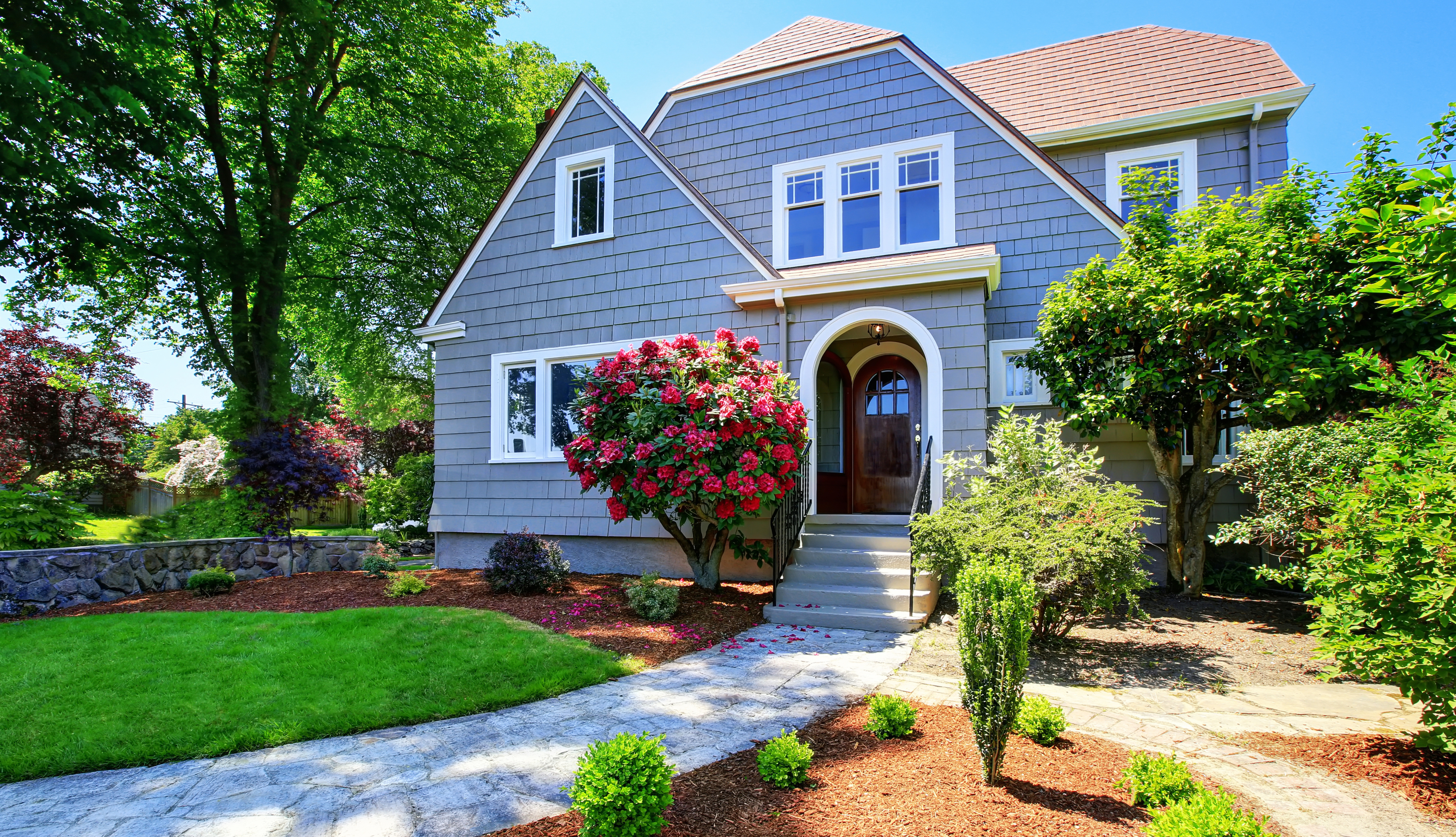 Blue craftsman style home exterior with clipped gable roof